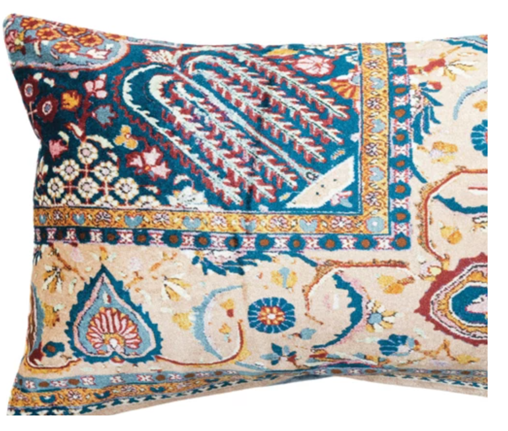 This rectangular lumbar pillow is a celebration of design and comfort. The cotton blend velvet fabric is adorned with a multi-colored vintage carpet pattern, offering both visual intrigue and a soft touch. The pillow's bohemian, eclectic, and global design influences make it a versatile addition to any transitional space.