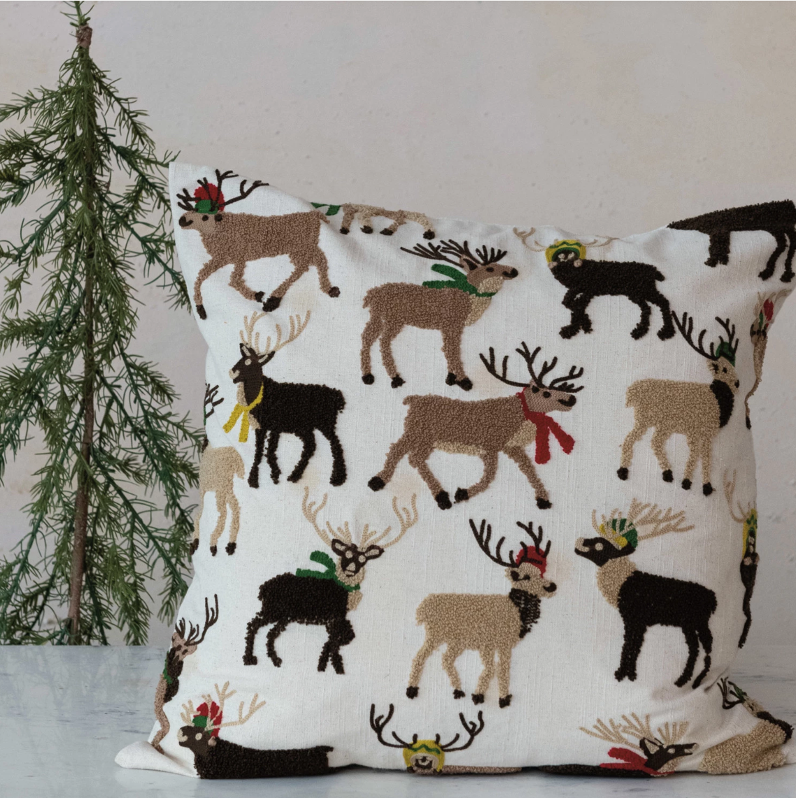 This 20-inch square cotton slub pillow is a charming addition to holiday decorations, showcasing a tufted and embroidered reindeer on a vibrant multicolor background. The cotton cover has a rustic texture that complements the festive design, while the polyester fill provides plush support, making it both a decorative and comfortable choice.