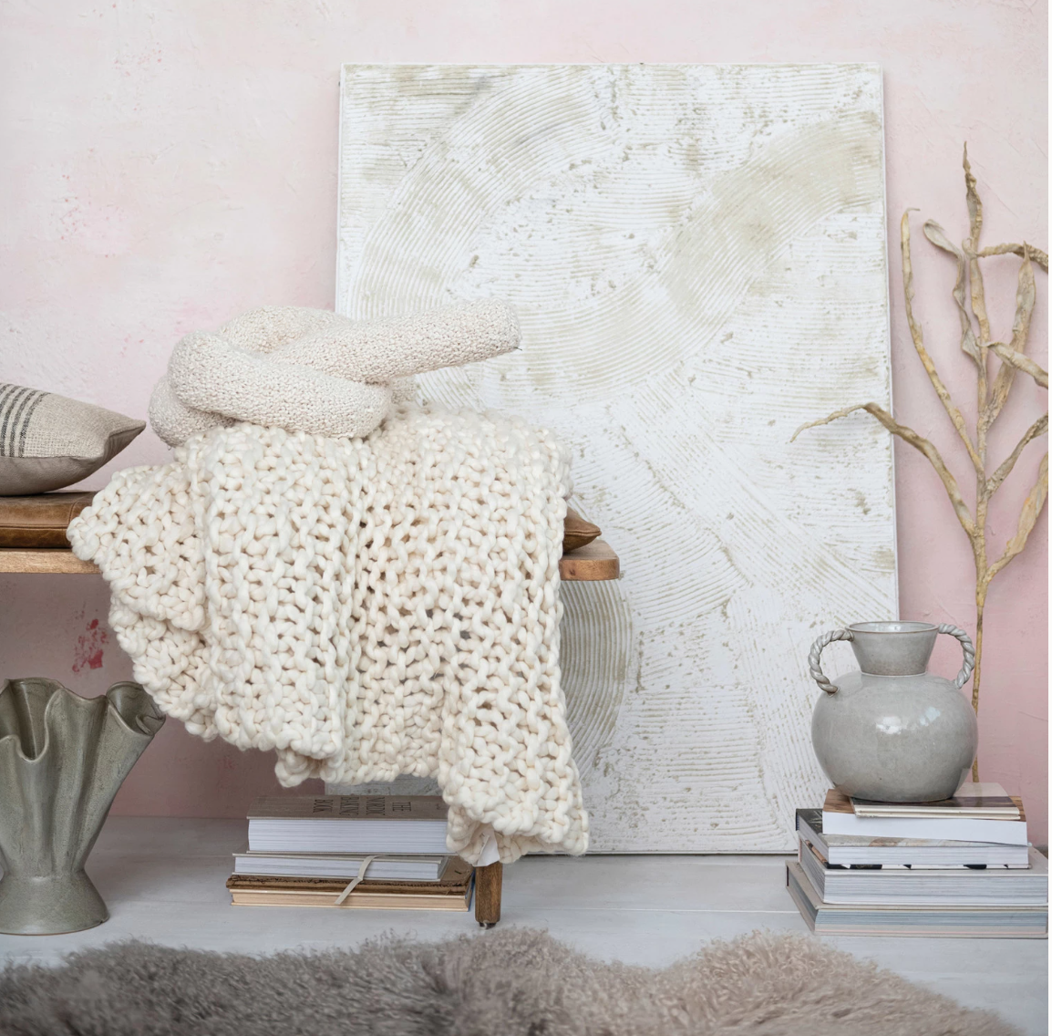 Enhance the home decor with this woven cotton bouclé knot pillow in cream. This pillow features a woven cotton bouclé fabric that creates a soft and cozy feel. The bouclé material is textured and curly, giving the pillow a unique and charming look. The cream color is neutral and elegant and can match any color scheme or theme.