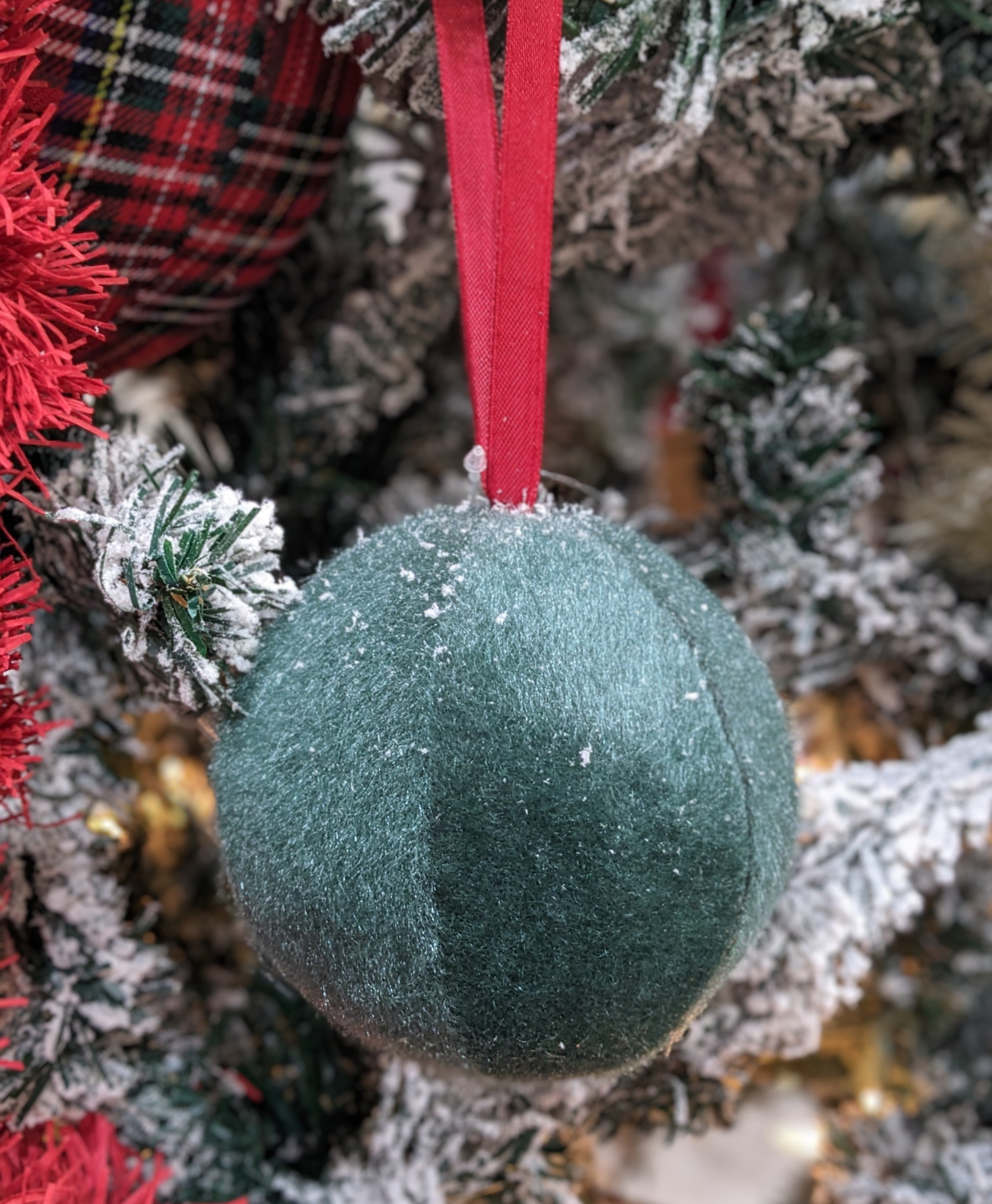 Brighten your space with our 4" Green Soft Ball Hanging Ornament. This charming piece features a lush, vibrant green hue and a plush texture, making it a delightful accent for any room. Perfect for hanging from ceilings, trees, or decorative displays, it adds a playful touch to your decor.