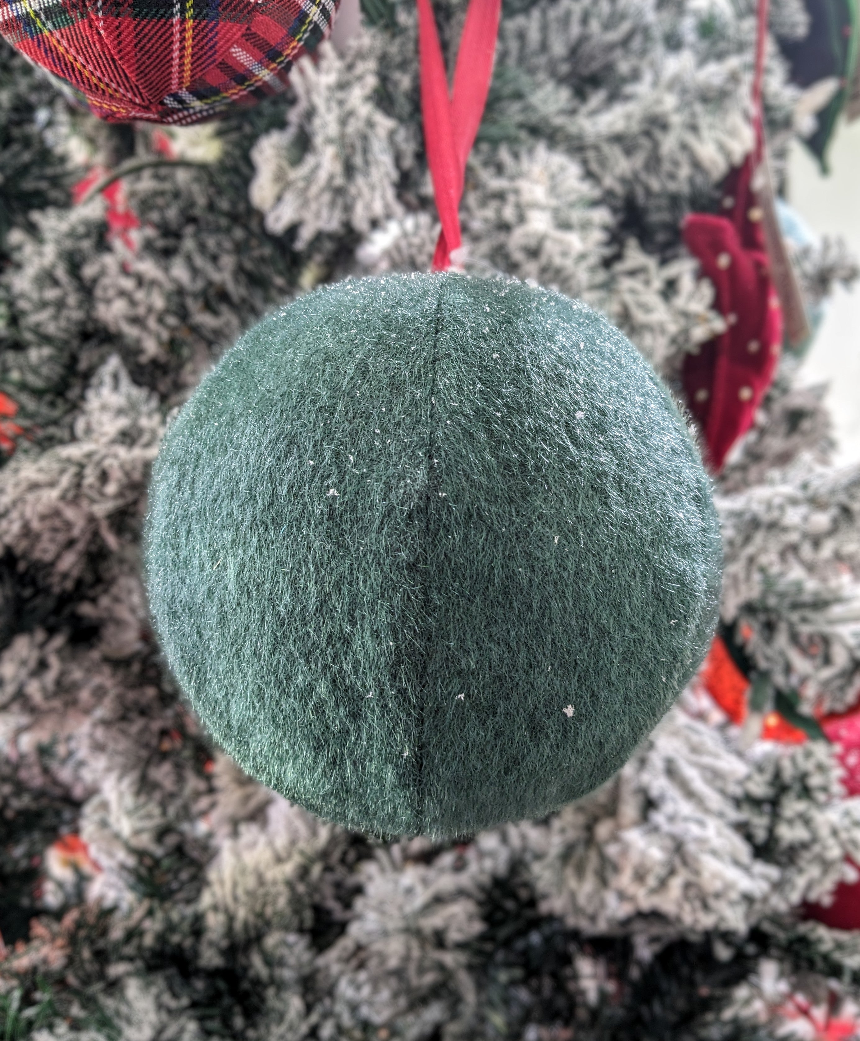 Elevate your home decor with our 5.5" Large Green Soft Ball Hanging Ornament. Perfect for adding a touch of whimsy to any space, this plush ornament features a rich, vibrant green hue that complements both modern and traditional styles. Whether you hang it from a ceiling, a tree, or a decorative branch, its soft texture and eye-catching design will create a cozy atmosphere in your home. 