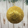 Add a touch of opulence to your holiday decor with our 5" Sequin Beaded Ball Ornament in Gold. This stunning ornament is beautifully embellished with shimmering sequins and beads, creating a radiant sparkle that catches the light perfectly.