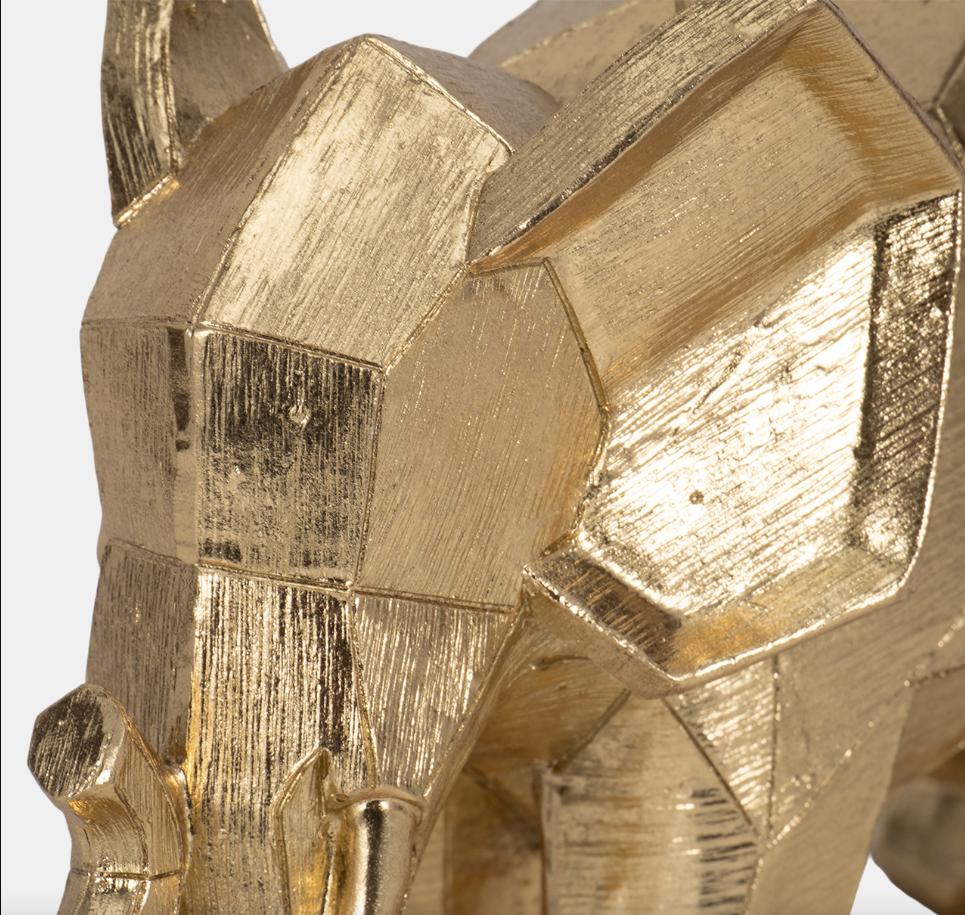 The Geometric Elephant is crafted from durable polyresin, giving it a refined metallic gold sheen that catches the light beautifully. Its unique geometric shape combines elegance with a modern flair, making it a versatile addition to both boho and glam interiors.