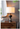 Crafted from a sturdy mix of iron and mango wood, this contemporary table lamp features a black and gray hue, a unique shape including a pedestal base and spherical ball in the middle of the frame, and a classic shade. An ideal size for your bedside table, a desk in your study, or a living room end table, it will catch the eye of your guests from any location. Measurements: 26H x 16D x 16W.