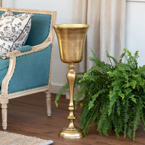 The bright gold finish adds to the festive atmosphere. No need to put it away after the party, it's also a perfect vessel for a fern or other plant.