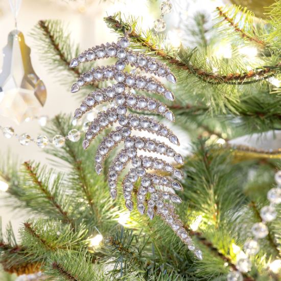 Our Champagne Gem Fern Frond Ornament is like jewelry for your tree. Combining the shape of a natural fern leaf and adding the glitz and glimmer of gems and glitter, this fancy frond will add sparkle to your holiday.