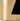 Close-up of a gold cylindrical object with a cutout design on a black background