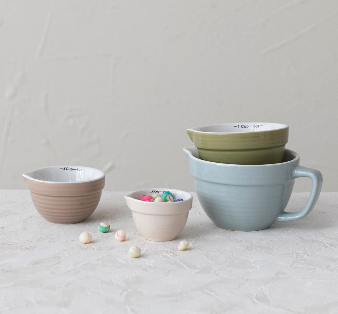 This classically designed set of batter bowl measuring cups features stoneware construction in 4 versatile hues. This piece is food safe. Dishwasher safe. Made from stoneware.