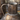 Rustic metal pitcher with a handle on a neutral background