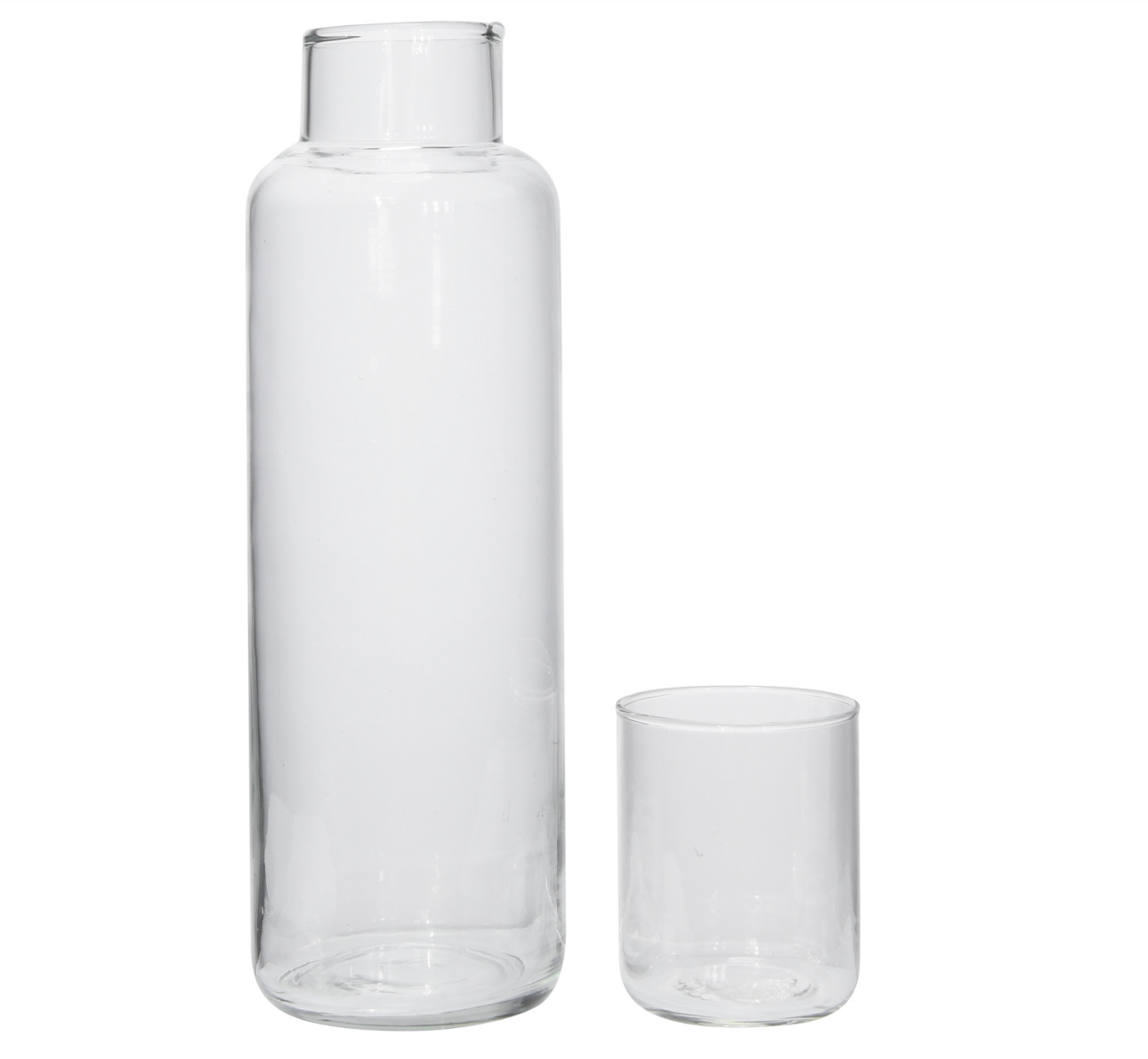 A clear glass decanter with a matching drinking glass, both are empty and set against a white background.