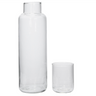 A clear glass decanter with a matching drinking glass, both are empty and set against a white background.