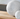 Two concrete spheres on a wooden surface with a neutral background