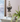 Decorative finial on books with a plant in the foreground