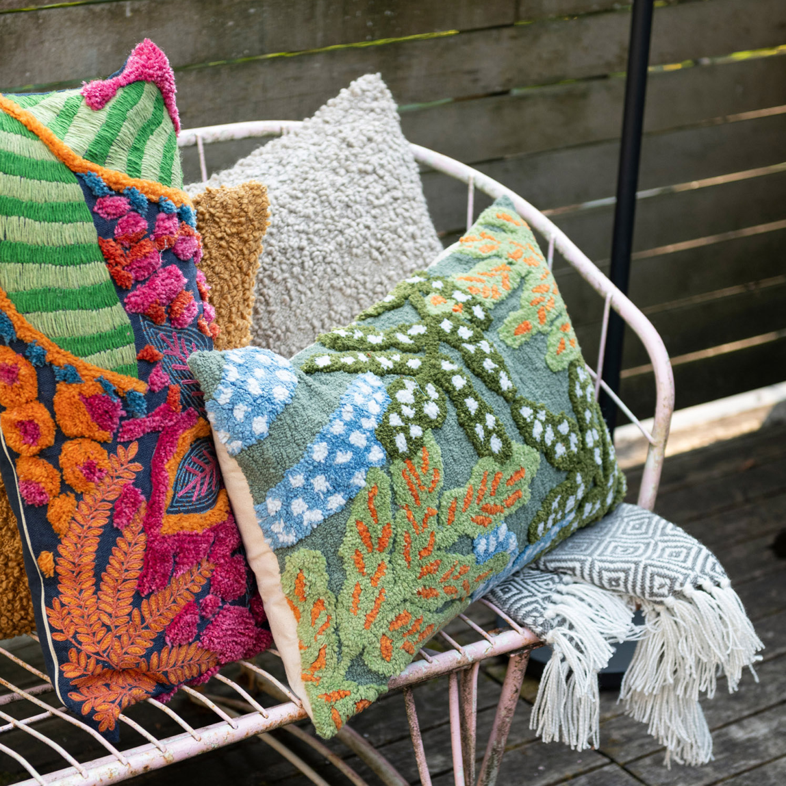 This embroidered fabric indoor/outdoor lumbar pillow features a vibrant and textured design with botanicals and tufting details. The pillow is a cozy addition to any space, adding charm and warmth. The multi-colored embroidered fabric gives it a vibrant and textured look, while the botanical design with tufting details adds personality and beauty. 