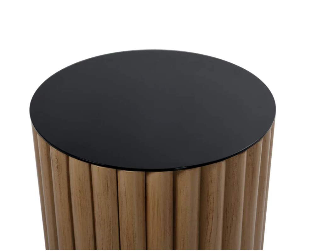  Crafted from natural pine wood, this exquisite piece boasts a unique fluted design that adds texture and depth to any room. The rich, warm tones of the pine wood are beautifully complemented by a sleek black glass table top, creating a striking contrast that enhances the table's elegant aesthetic.