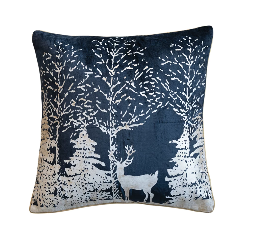 This square cotton velvet printed foil pillow is a celebration of winter's charm, depicted in a stunning navy blue and white color scheme. The front showcases a serene winter scene in white foil print, bringing a touch of festive elegance to any room. 