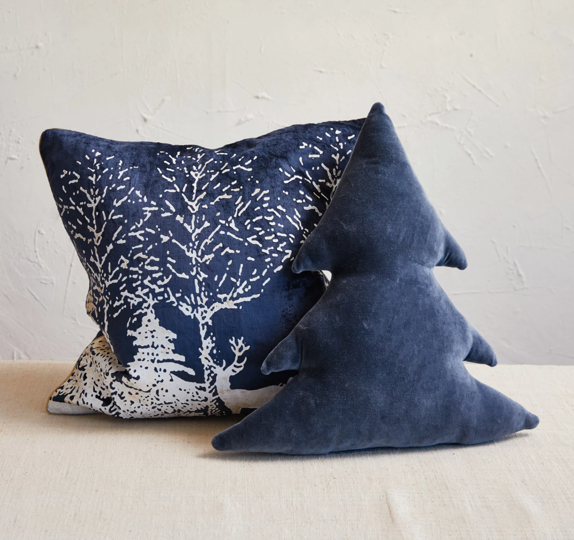 This square cotton velvet printed foil pillow is a celebration of winter's charm, depicted in a stunning navy blue and white color scheme. The front showcases a serene winter scene in white foil print, bringing a touch of festive elegance to any room. 