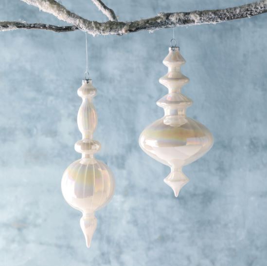 Our Frosty Pearl Glass Finial Ornaments are a glacial duo in two assorted styles. Their pearlescent hand finish adds glisten and shine to their milky white color. These delicate ornaments add a whimsical touch to arctic themed décor.