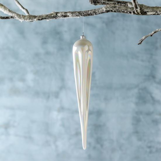 Our Frosty Pearl Glass Icicle Ornament is a dramatically elongated bauble at 14” in length with a pearlescent hand finish that adds glisten and shine to their milky white color. The statement ornament is a perfect way to add a whimsical touch to frosty themed décor.