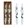 A set of two white taper candles with black bat accents, presented in a decorative box.