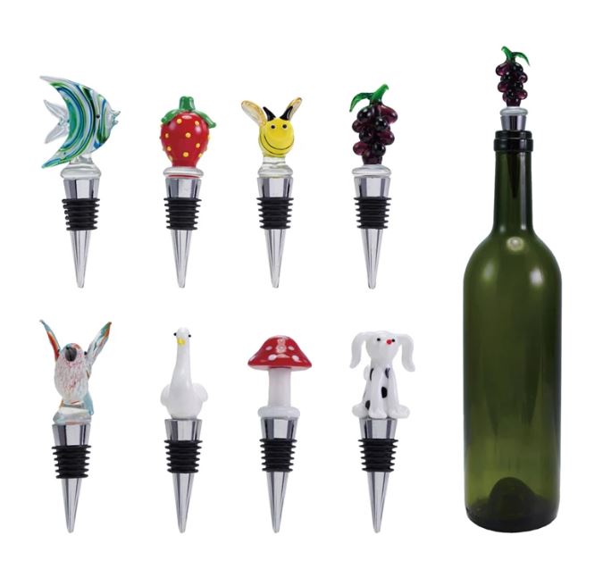 A collection of hand-blown glass bottle stoppers with zinc alloy bases in various colorful designs, displayed on top of a wine bottle.
