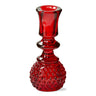 The candle holder features a unique reversible design, with one side for tea lights and the other side for taper candles. It is made from high-quality glass, which is durable and easy to clean.