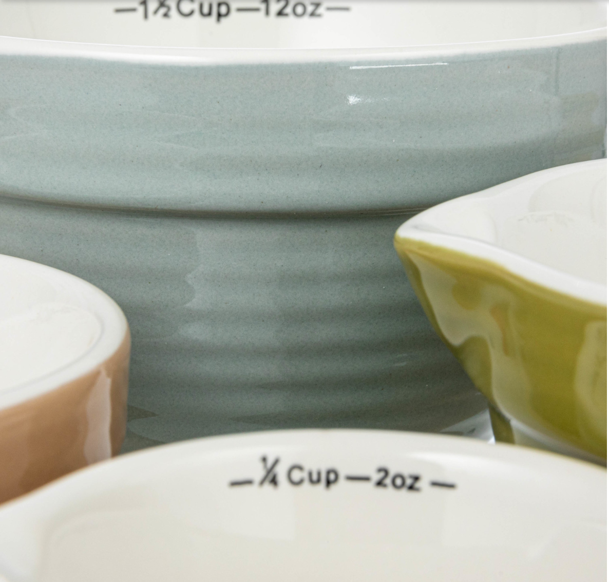 This classically designed set of batter bowl measuring cups features stoneware construction in 4 versatile hues. This piece is food safe. Dishwasher safe. Made from stoneware.