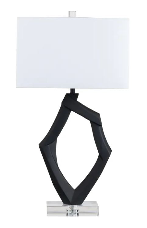 Introducing the Laurence Whimsical Table Lamp, a unique and artistic addition to your home decor. Standing at 31.25 inches tall with dimensions of 17 inches in length and 11 inches in width, this lamp features a striking organic shape crafted from durable resin.