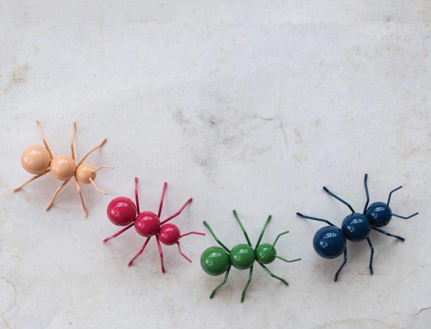 Metal ants in various colors including beige, pink, green, blue, and yellow, each with a whimsical decorative design.