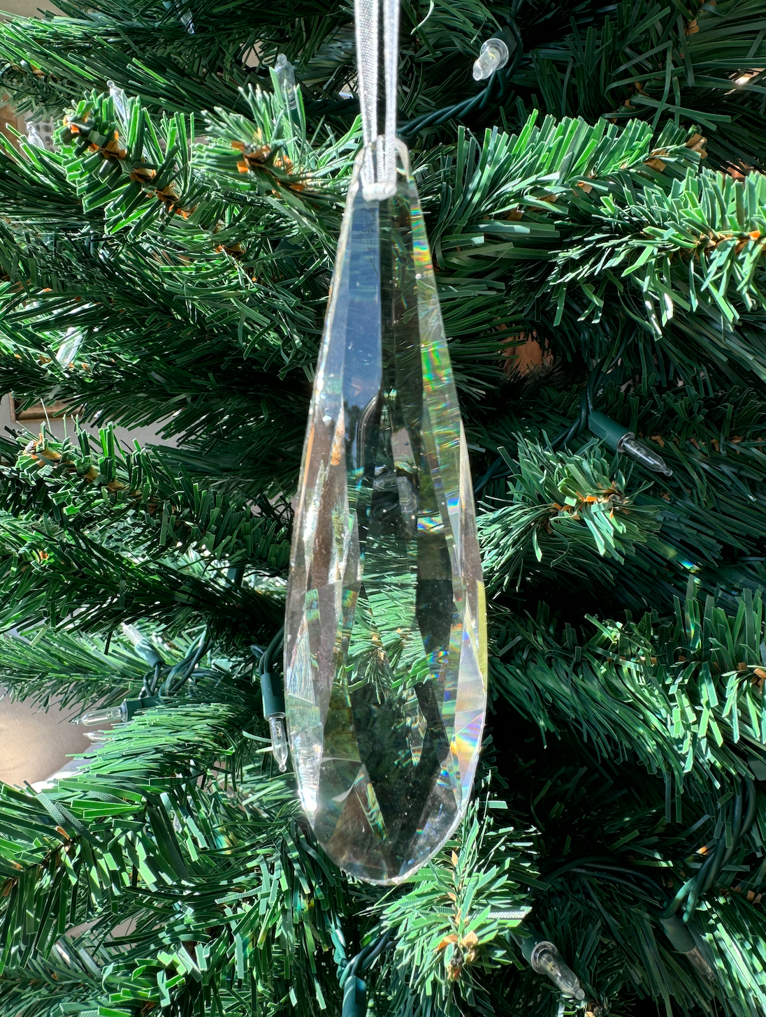 This stunning piece features a sparkling crystal design that catches the light beautifully, creating a mesmerizing effect on your Christmas tree or festive displays. Its sleek shape and brilliant shine make it a perfect accent for both traditional and contemporary decor styles. Whether hung among other ornaments or showcased on its own, this crystal drop ornament brings a sophisticated sparkle to your holiday celebrations, elevating your festive atmosphere!