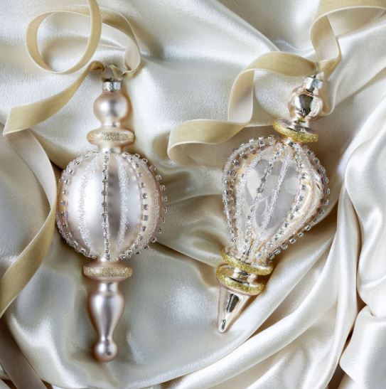 Each finial boasts a frosted glass finish adorned with shimmering rhinestone patterns that catch the light beautifully, adding a touch of glamour to your holiday decor. These elegant ornaments are perfect for creating a sophisticated and festive atmosphere, whether hanging from tree branches or displayed as part of your holiday centerpiece. With their unique designs, these finials are sure to become cherished pieces in your seasonal collection, making your celebrations truly special.