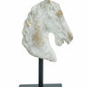 Masterfully crafted by skilled artisans, this decorative statue features an intricately detailed horse head, complete with a natural gray finish, occasional flashes of gold, and a sturdy black iron base for both stability and contrast. Whether it is displayed on its own or as part of a nature-inspired vignette, it is sure to infuse your home decor with a regal, commanding air.