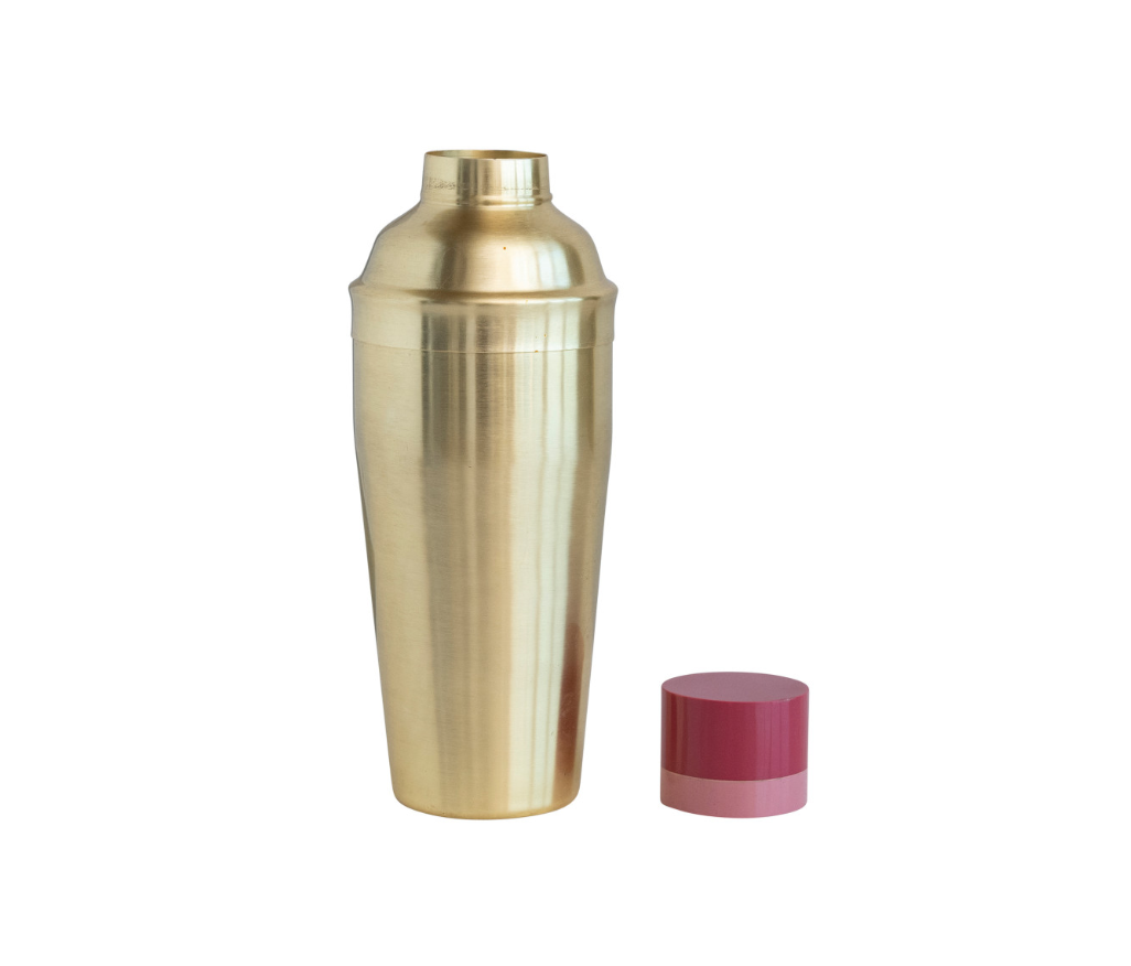 A gold stainless steel cocktail shaker with a two-tone red and beige resin lid.