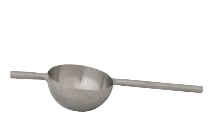 A stainless steel peg measure, consisting of a bowl-shaped end and a long handle.
