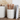 A beige stoneware canister with raised dot patterns and an acacia wood lid.