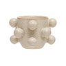 A round stoneware planter with speckled cream color and reactive glaze, featuring multiple orbs on the side.