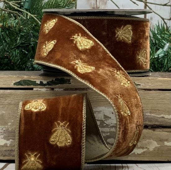 Measuring 2.5" wide and 5 yards long, this luxurious ribbon features delightful bee embroidery, beautifully contrasting against the rich brown velvet. Perfect for gift wrapping, crafting, or enhancing floral arrangements, its soft texture and unique design make it a versatile choice for any occasion. Bring a whimsical yet elegant flair to your creations with this charming ribbon that celebrates nature's beauty!