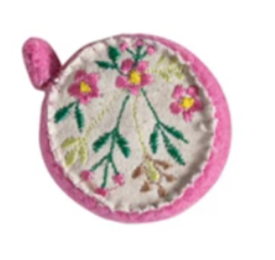 Small round Wool Felt Tape Measure with floral embroidery and pink border on a white background
